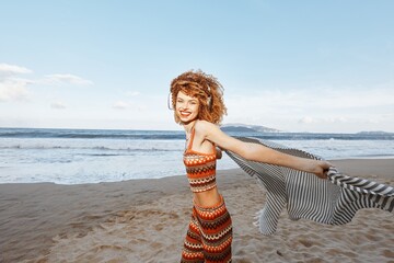 Wall Mural - Summer Bliss: Smiling Woman Embracing Freedom at the Beach