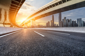 Wall Mural - Asphalt highway road and bridge with modern city buildings scenery at sunset in Guangzhou. car advertising background.