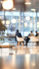 Poster - A blurred image of a modern office with people working at desks in the background. The image is taken from a low angle, with the focus on the table in the foreground