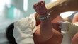 © Marco - Newborn baby wearing personalized bracelet with name, getting dressed by parent in hospital, close-up of tiny hand and wrist with name beads, symbolizing love and care