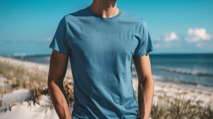 Male wearing a blue t-shirt mockup on the beach