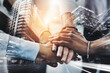 © peopleimages.com - Double exposure, city and people with pile of hands in meeting for teamwork, collaboration and partnership. Business, employees and deal for urban or infrastructure development as property developer