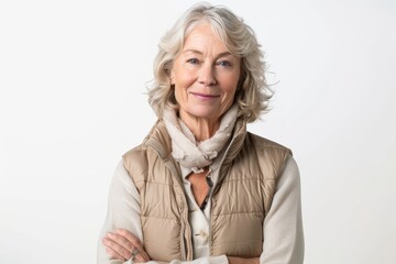 Poster - Portrait of a happy woman in her 60s dressed in a thermal insulation vest in front of white background