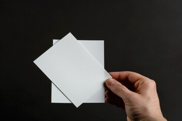 Poster - A person holds a piece of paper in their hand