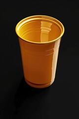 Poster - A bright yellow plastic cup sitting on a dark black surface