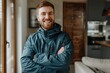 © CogniLens - Portrait of a happy caucasian man in his 20s wearing a windproof softshell over modern minimalist interior