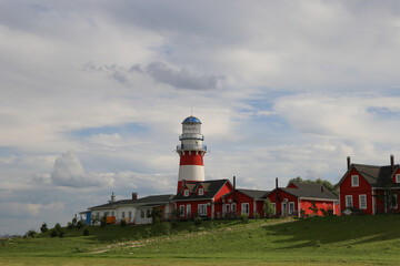 White-red lighthouse in a fishing village