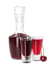 Wall Mural - Bottle and shot glasses of delicious cherry liqueur isolated on white