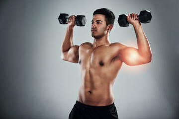 Canvas Print - Person, dumbbell and muscle injury in studio, growth and ache for weightlifting, power or health by grey background. Man, bodybuilder and red glow for pain, overlay and accident for bicep in workout