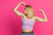 © Andrii Iemelianenko - I am strong and independent. Caucasian young woman showing biceps and looking confident, feeling power strength to fight for rights, energy to gain success win. Blonde girl isolated on pink background