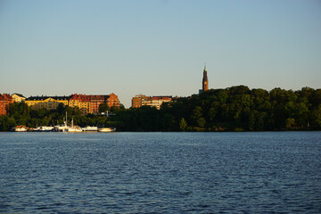 Wall Mural - Scenic view of river by buildings against clear sky