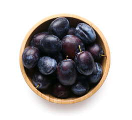Wall Mural - Bowl with ripe plums on white background