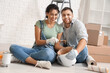 © Pixel-Shot - Beautiful young happy couple with paint can and brush doing repair in new house