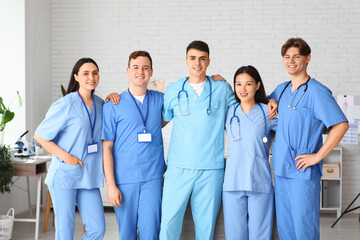 Wall Mural - Group of young doctors hugging in clinic