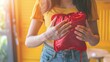 © Nicat - Monthly menstrual cycle, Asian young woman with pain in her hand, premenstrual syndrome, abdominal or belly pain, and use of a hot water bag. Health issue Body inflammation
