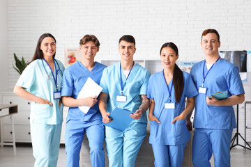 Poster - Group of young doctors in clinic