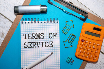 Poster - TERMS OF SERVICE text written on paper clipboard on laptop