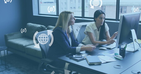 Poster - Image of globe icons in arrows over diverse female coworkers discussing reports on computer