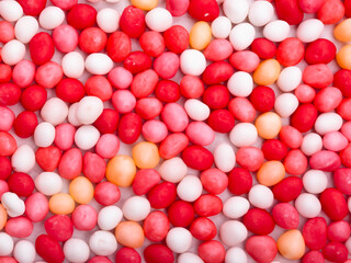 Sticker - many different color candies as background, top view