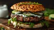 © nitiroj - Herb-crusted lamb burger with mint yogurt sauce, cucumber, and arugula, on a toasted pita bread