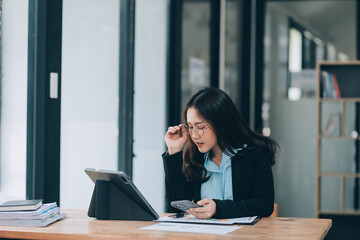 Wall Mural - Asian woman working at the office. woman using laptop computer on desk at office