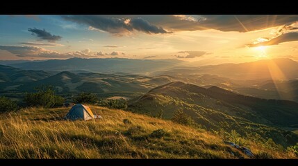 Wall Mural - A scenic campsite on a hilltop overlooking a sprawling valley bathed in the golden light of the setting sun.