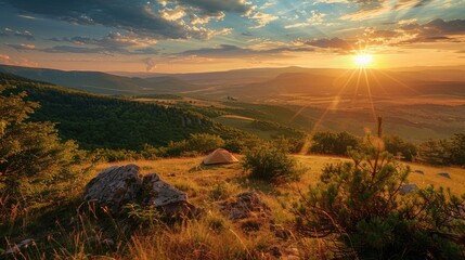 Wall Mural - A scenic campsite on a hilltop overlooking a sprawling valley bathed in the golden light of the setting sun.