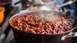 © Justlight - A pot of steaming aromatic chili made with a blend of ground wild game and beans.