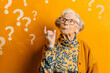 © Emanuel - Elderly woman puzzled by question marks, confusion and thought