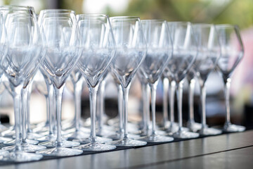 empty wine glasses arranged in rows on a table