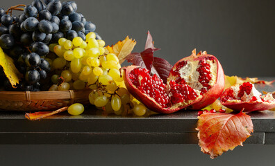 Wall Mural - Ripe juicy grapes and pomegranate.