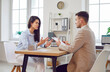 © Studio Romantic - Thoughtful young woman and male business worker working at desk, talking on business interview questions, prepare for meeting, planning budget to discuss finances, startup, individual entrepreneurs
