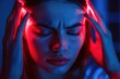 © Boomanoid - Woman experiencing headache under red and blue lights