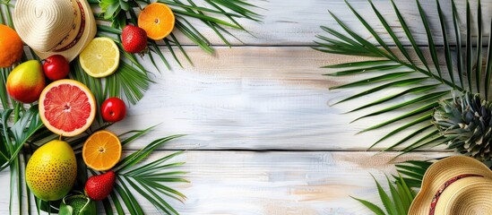 Sticker - Tropical foliage and fruits, straw hat, summertime theme on white wooden backdrop. Empty space provided. Overhead view