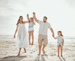 © peopleimages.com - Beach, swing and kids with parents holding hands at sunset for morning games, freedom and adventure in nature. Support, lifting and happy family at ocean for travel, journey or fun bonding in Cancun