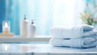 © Fang - Blurred bathroom interior background and blue spa towels on white marble desk, generative ai