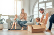 © peopleimages.com - Family, dad and girl with box in new home for relocation, playing or real estate. Children, parents and man with daughter for property investment, happiness or bonding together in living room