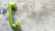 © Oleksiy - Green telephone handset on light background, top view. Space for text