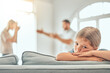 © peopleimages.com - Divorce, sad and child on sofa with parents in argument for conflict, disagreement or fighting in living room. Young girl, angry man with woman for paternity test, distrust or wife with affair
