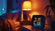 © Lakkhana - Glowing numbers of a digital bedside clock in a dark room