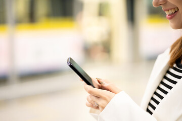 Close up hand asian woman using smartphone application navigate location destination while travel by subway. Female holding cell phone while traveling in train transport