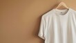 © Elmira - A close-up image of a white t-shirt mockup hanging on a wooden hanger against a neutral background. The shirt is blank and ready for design, offering plenty of copy space on the right