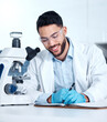© peopleimages.com - Man, microscope and writing research in lab, experiment and innovation study for vaccine development. Science, notes and hypothesis for medical researcher, biotechnology and cure engineering