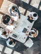 © Pascal - Top view of group of multiethnic busy people working in an office, Aerial view with businessman and businesswoman sitting around a conference table with blank copy space, Business meeting concept