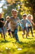 © Nate the Cat - Happy children group running, playing, sunny, park, kids smiling enjoying active day outdoors