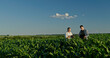 © StockMediaSeller - Two farmers from different generations collaborating in a cornfield, using a laptop. Concept of learning and knowledge transfer