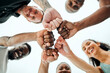 © Oostendorp/peopleimages.com - Sky, fist bump and hands of people with fitness for teamwork, support or running motivation. Low angle, diversity and group of friends with smile for synergy, community or race in morning in nature