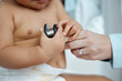 © KayJoint/peopleimages.com - Stethoscope, hands of baby and doctor in clinic for check up, healthcare and progress for growth. Child, pediatrician and touching equipment for post natal assessment, development and cardiology