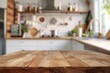 © qorqudlu - A focused shot of a wooden table surface with a defocused kitchen area, great as a wallpaper or background for culinary concepts