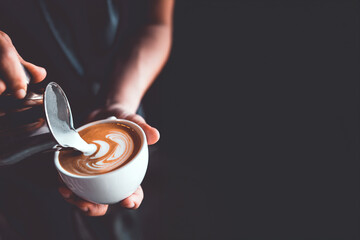 vintage tone of barista pour milk to making latte art coffee at cafe or coffe shop